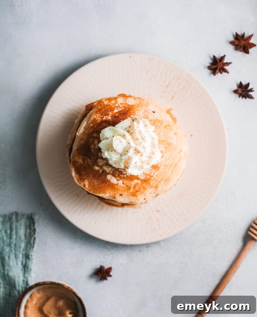 Eggnog Pancakes topped with generous cinnamon whipped cream and a sprinkle of nutmeg