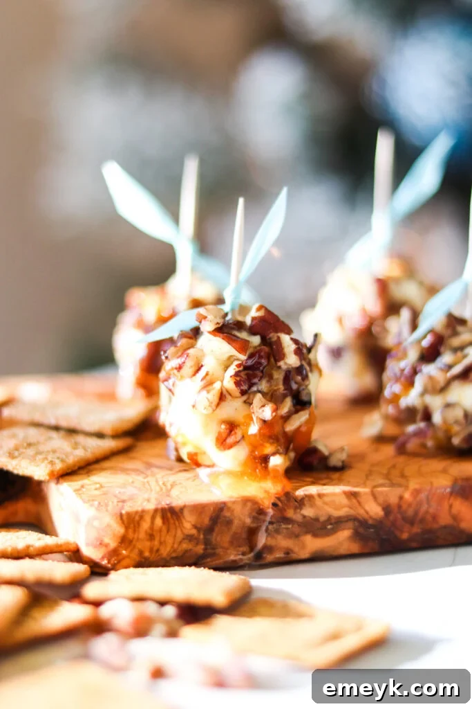 Honey Goat Cheese Balls with toothpicks on a rustic board, ready to be served as an appetizer.