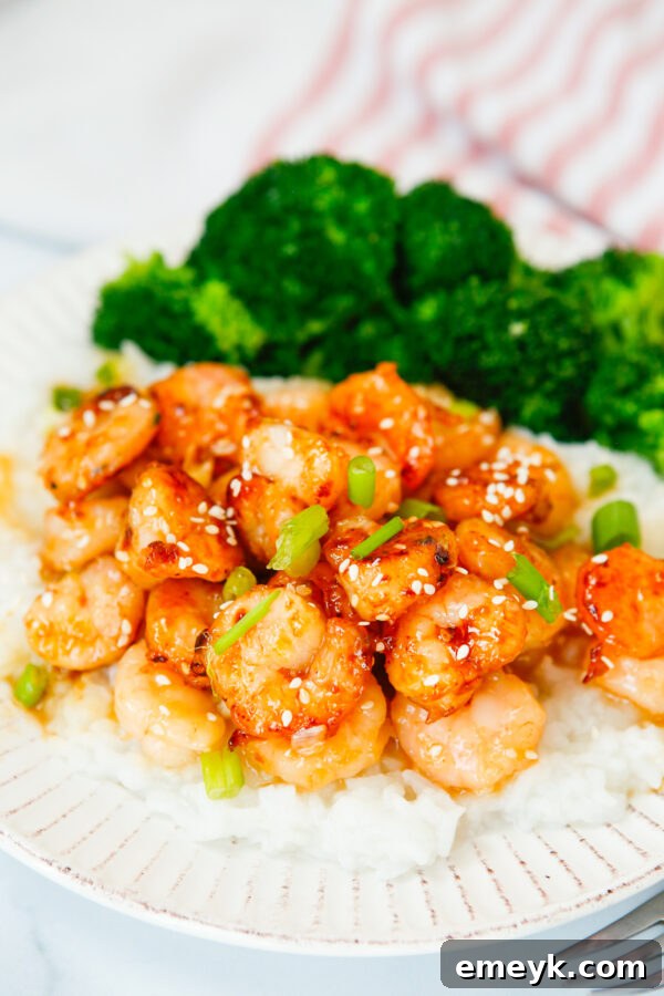 Sticky Sriracha Honey Garlic Shrimp 4 Honey Garlic Sriracha Shrimp being cooked in a skillet with broccoli on the side.