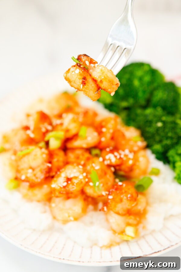 Sticky Sriracha Honey Garlic Shrimp 8 Honey Garlic Sriracha Shrimp ready to be eaten, garnished with fresh green onions and sesame seeds.