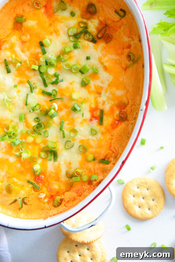 Creamy Buffalo Chicken Dip served in a white bowl with dippers, ready to eat