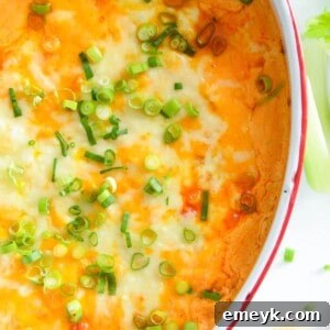 Delicious Buffalo Chicken Dip in a square dish, with fresh scallions, ready to be served