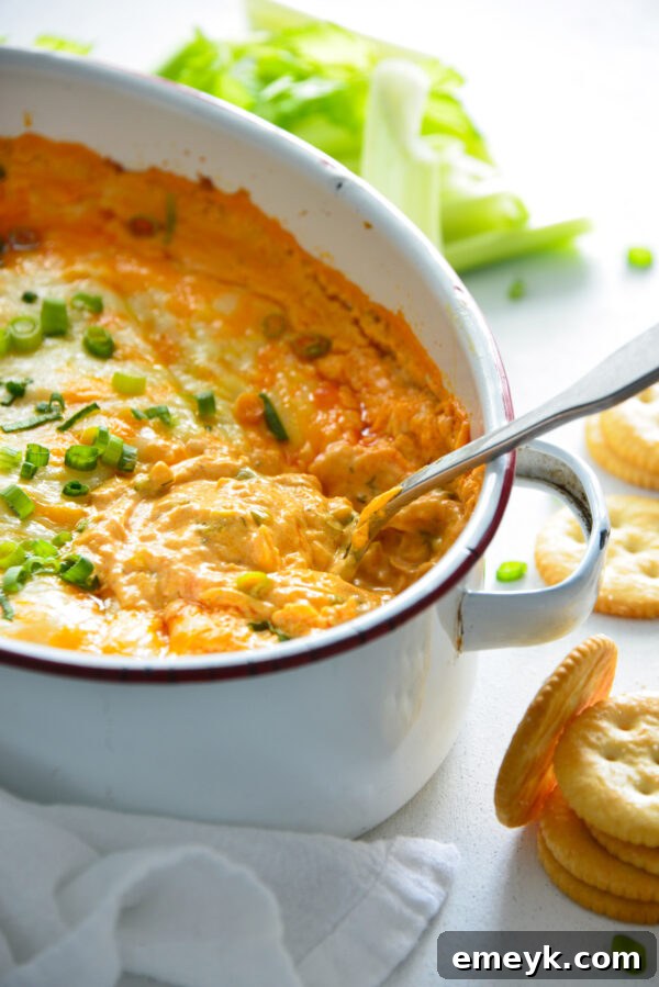 A large mixing bowl with a spoon, showing the creamy ingredients beginning to combine