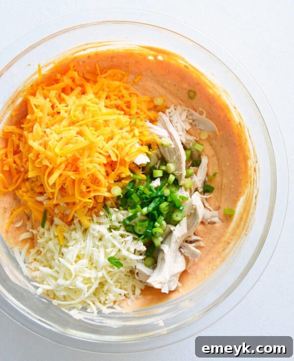 All buffalo chicken dip ingredients mixed together in a large bowl