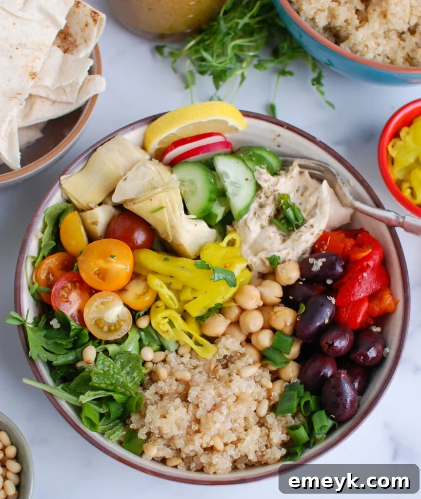 Greek Quinoa Bowl with colorful vegetables and hummus