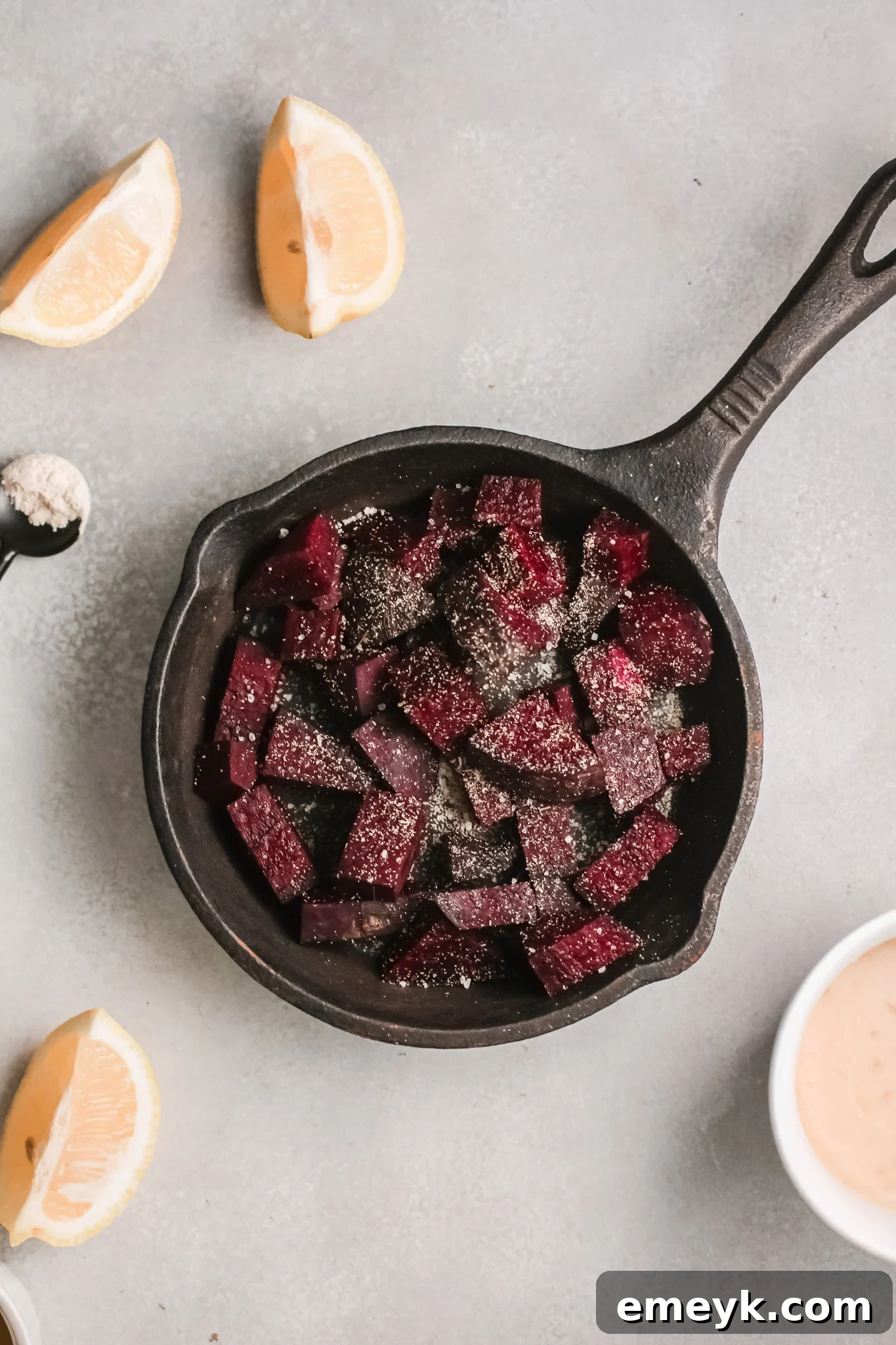 A food processor filled with roasted beets, ready to be blended into hummus.