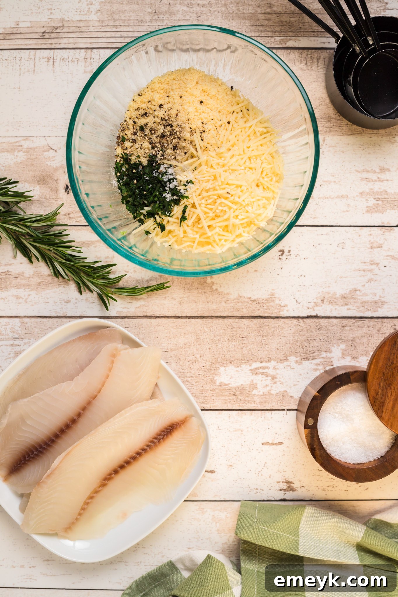 Mixing fresh herbs and spices with Parmesan cheese and breadcrumbs for the tilapia crust.