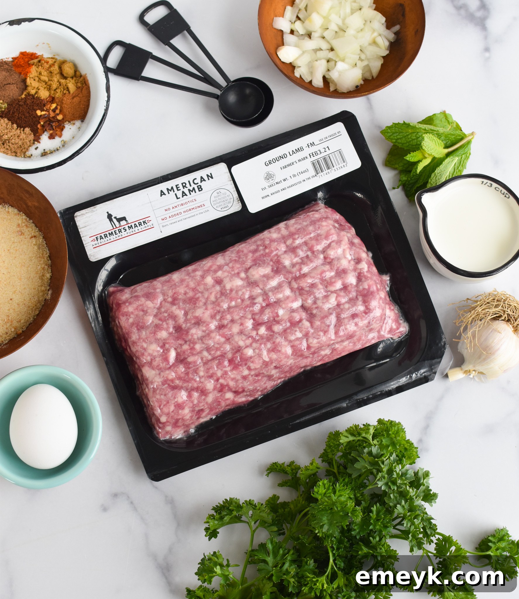 Spiced Lamb Kofta 4 All the fresh and flavorful ingredients for Lamb Kofta are neatly arranged on a rustic wooden table, including ground lamb, fresh mint and parsley, garlic, onion, and a vibrant assortment of Middle Eastern spices.
