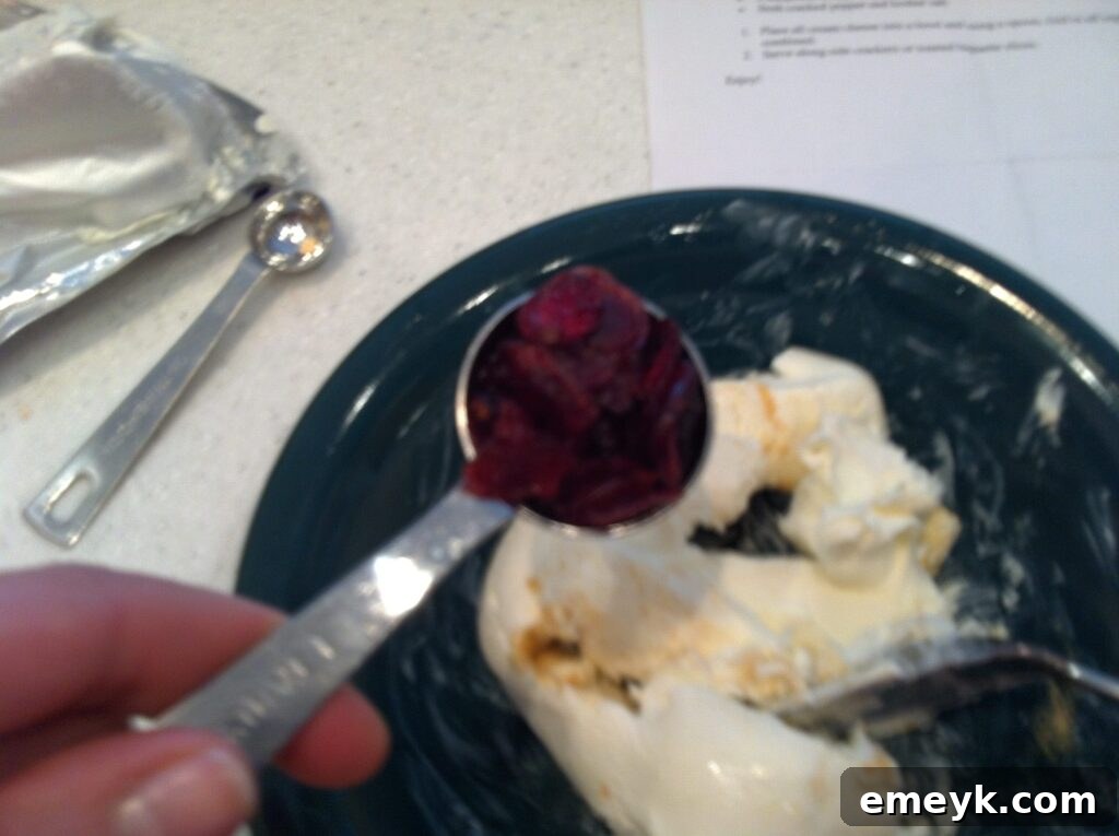 Dried cranberries and chopped fresh rosemary added to the cream cheese and garlic powder mixture.