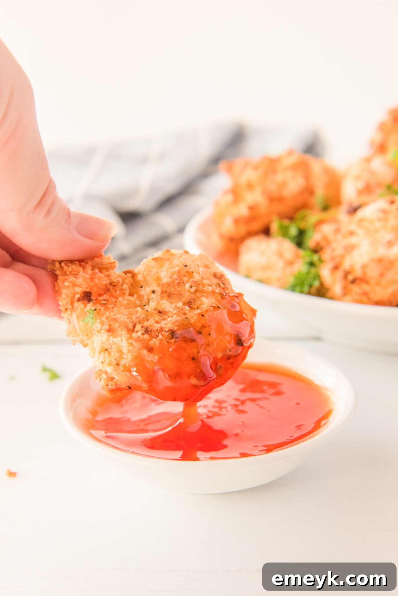 Crispy Air Fryer Coconut Shrimp with a vibrant dipping sauce, served on a rustic plate.