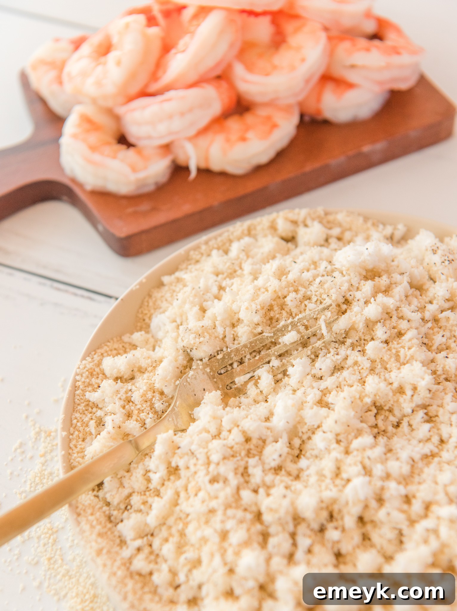 Whisked eggs in a bowl, ready for dipping shrimp.