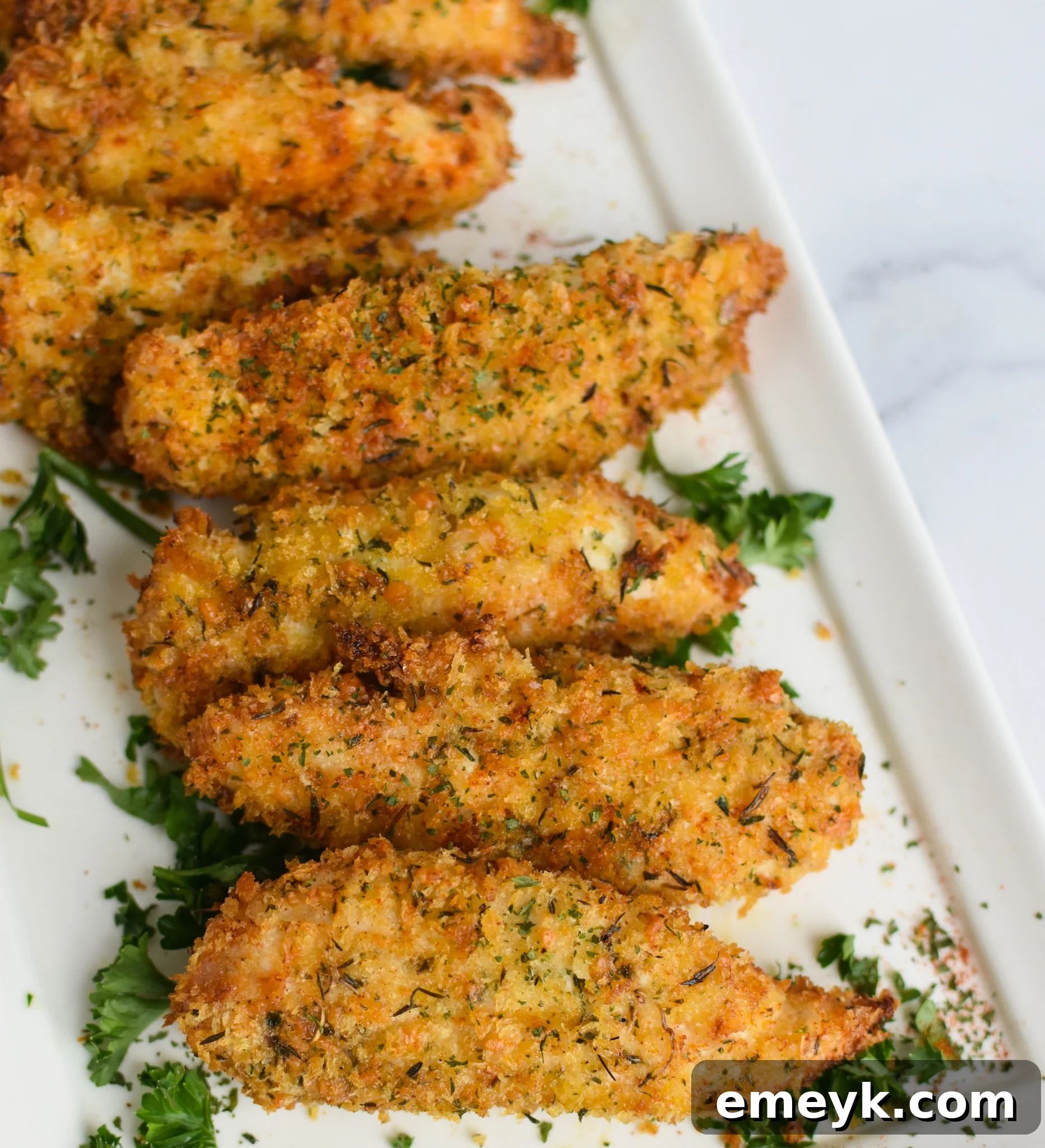 Golden Crispy Air Fryer Chicken Tenders 2 Air Fryer Chicken Tenders on white plate