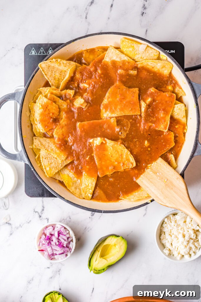 Chilaquiles Rojos Recipe: Sautéing onions in a skillet.