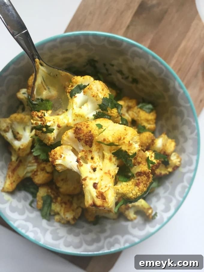 17 Effortless Sides to Elevate Your Fish Meal 8 Flavorful Curry Roasted Cauliflower topped with cilantro.