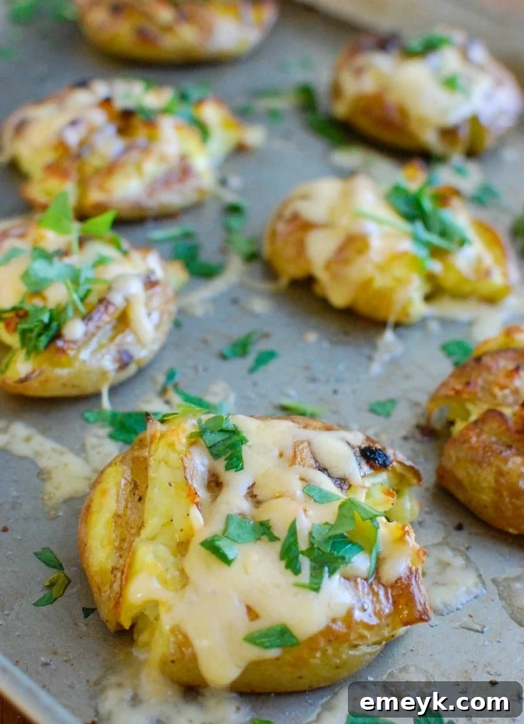 17 Effortless Sides to Elevate Your Fish Meal 9 Crispy Gouda Smashed Potatoes topped with melted cheese.