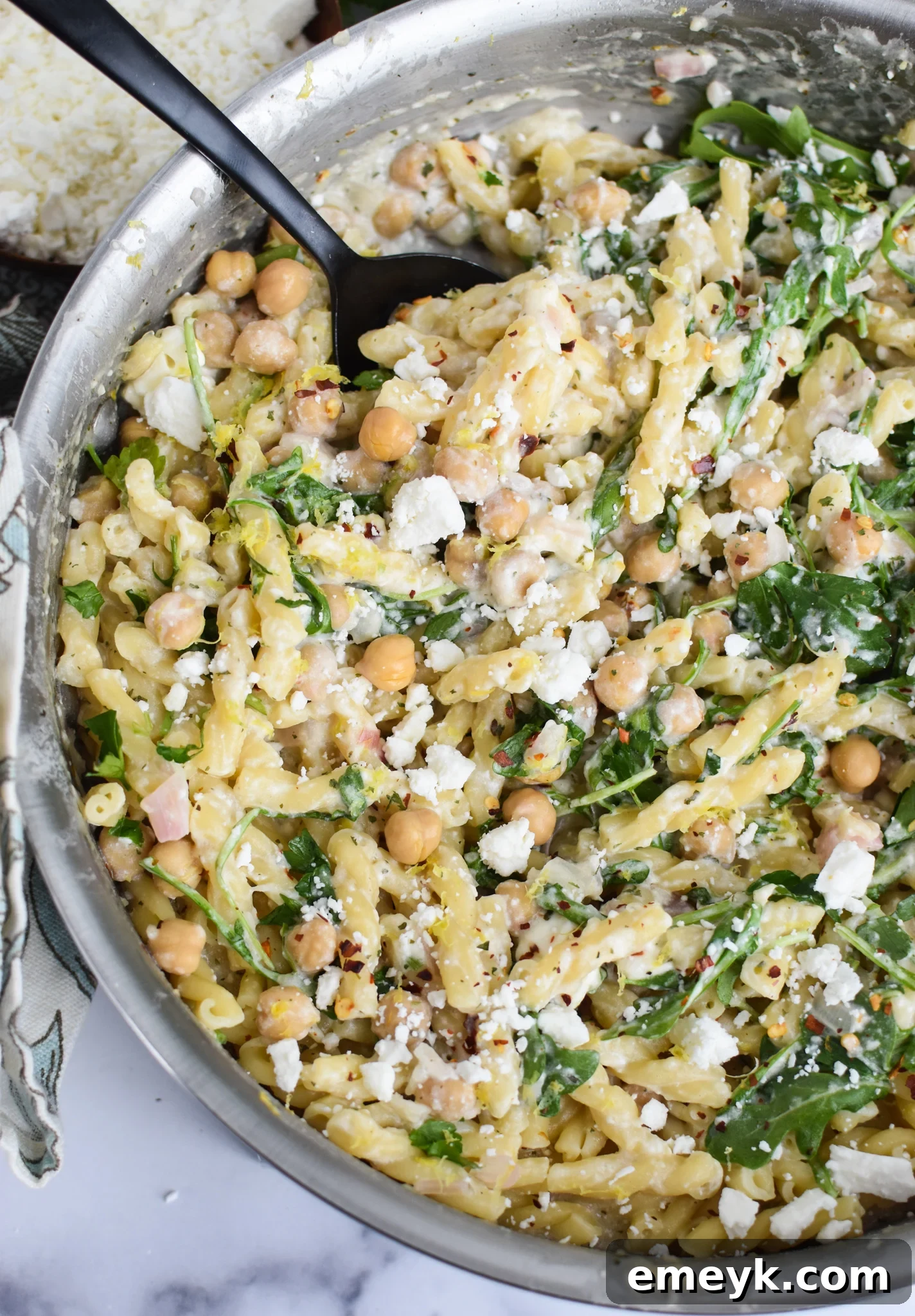 Chickpea Pasta with Feta being mixed in a large pot.
