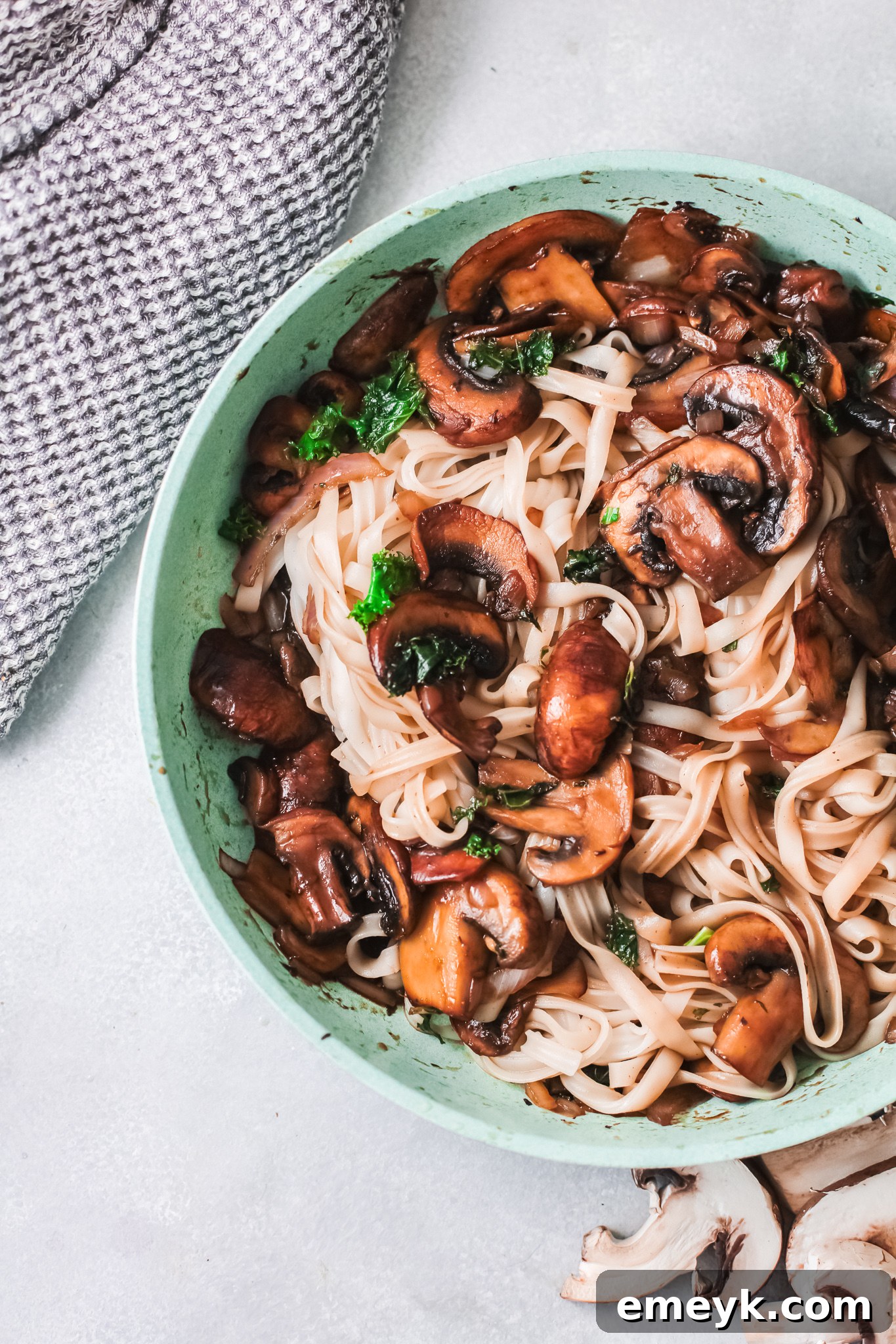 Easy Korean Noodles Recipe being prepared in a teal skillet, showcasing the vibrant ingredients.