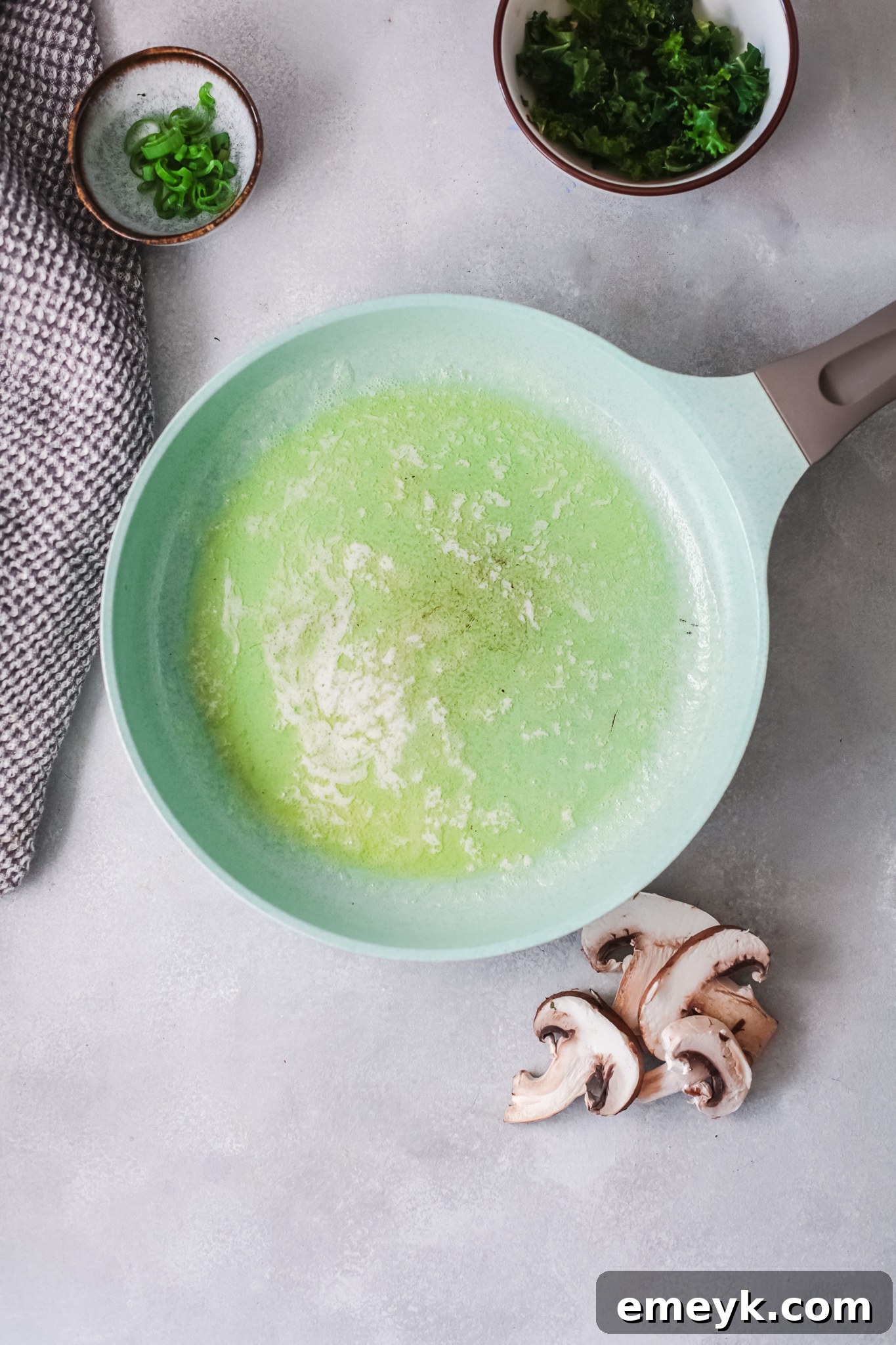 A skillet with melted butter and sesame oil, ready for cooking.