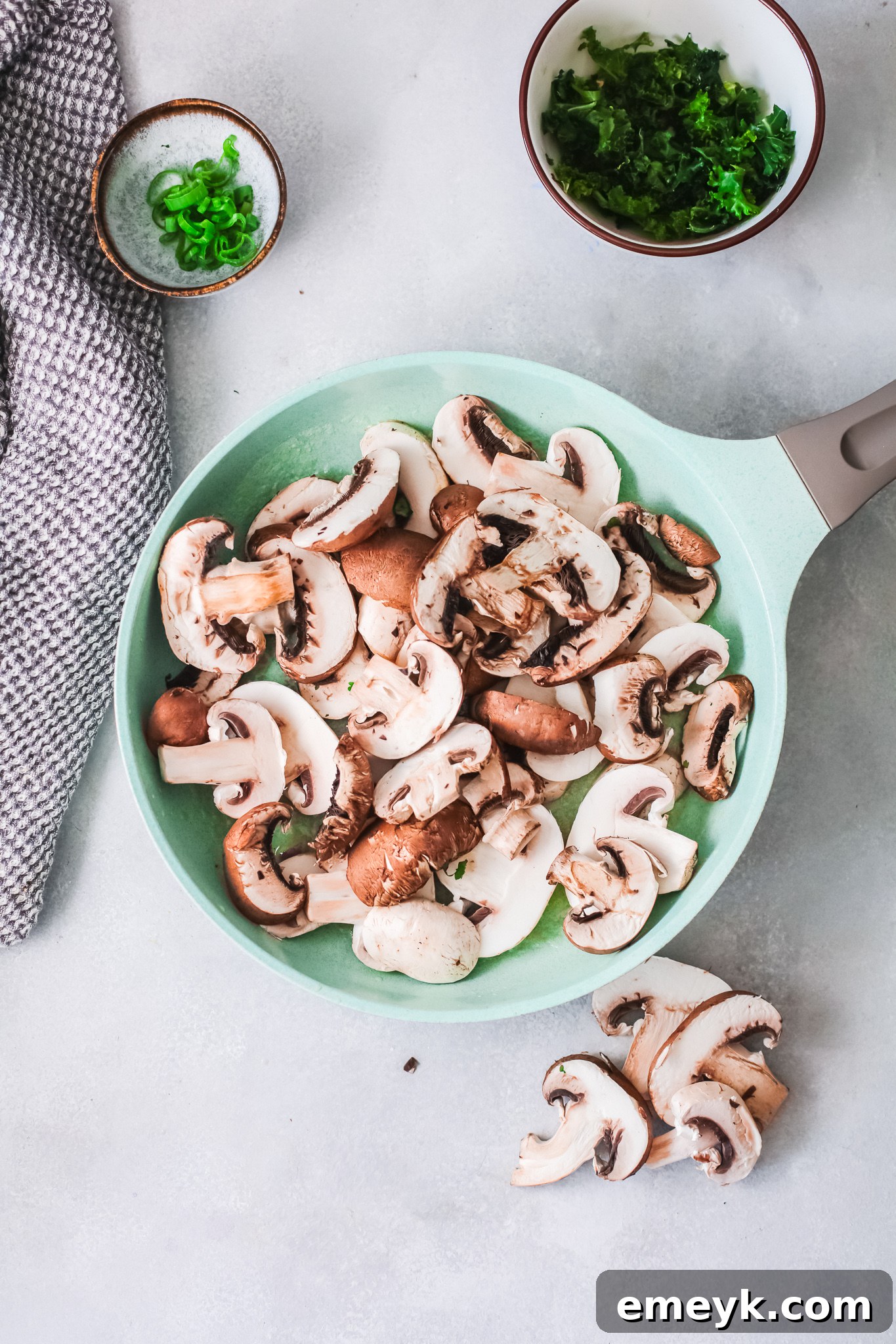 Sliced mushrooms caramelizing in a skillet, turning golden brown.