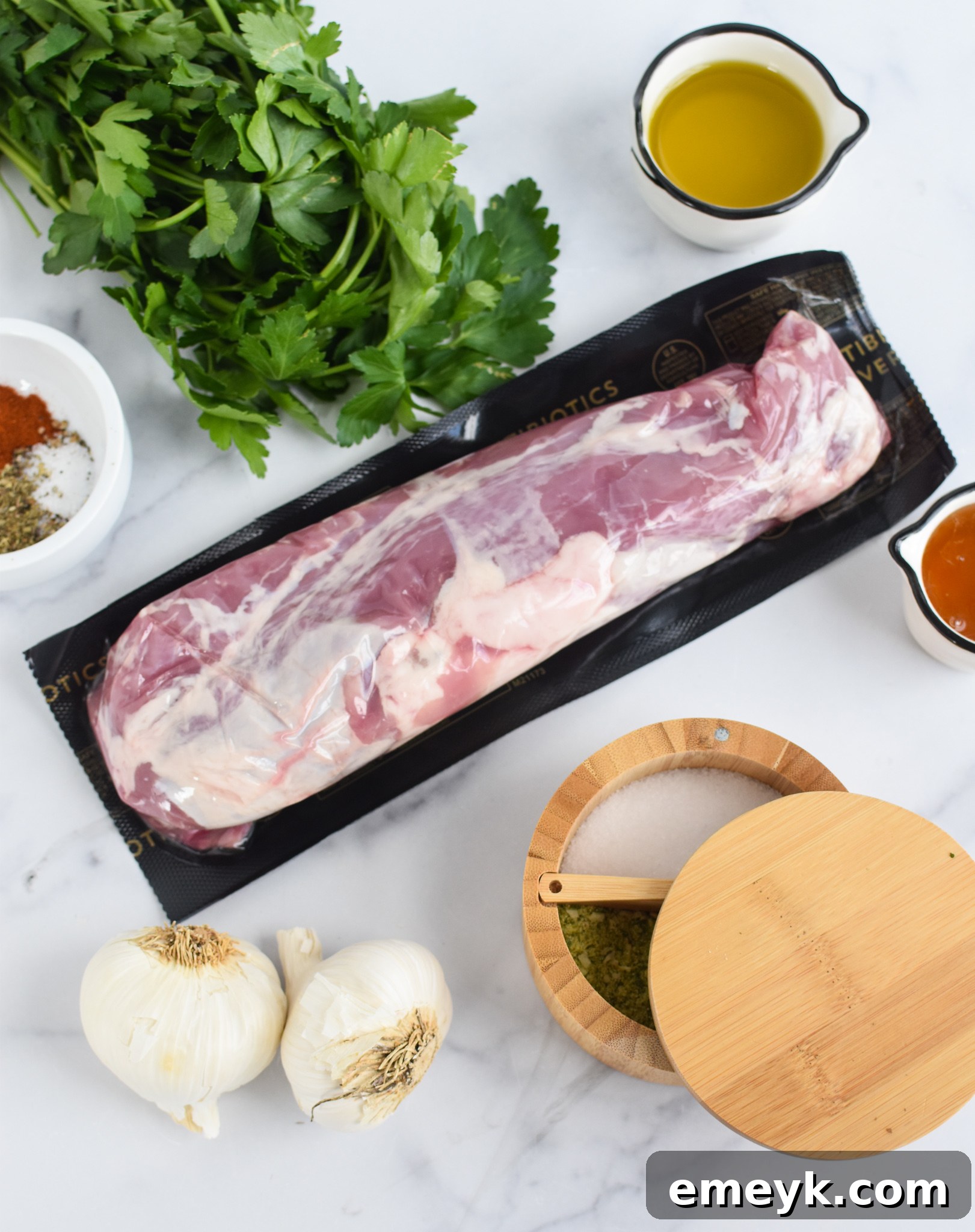 Fresh ingredients for Cast Iron Pork Tenderloin laid out on a cutting board.
