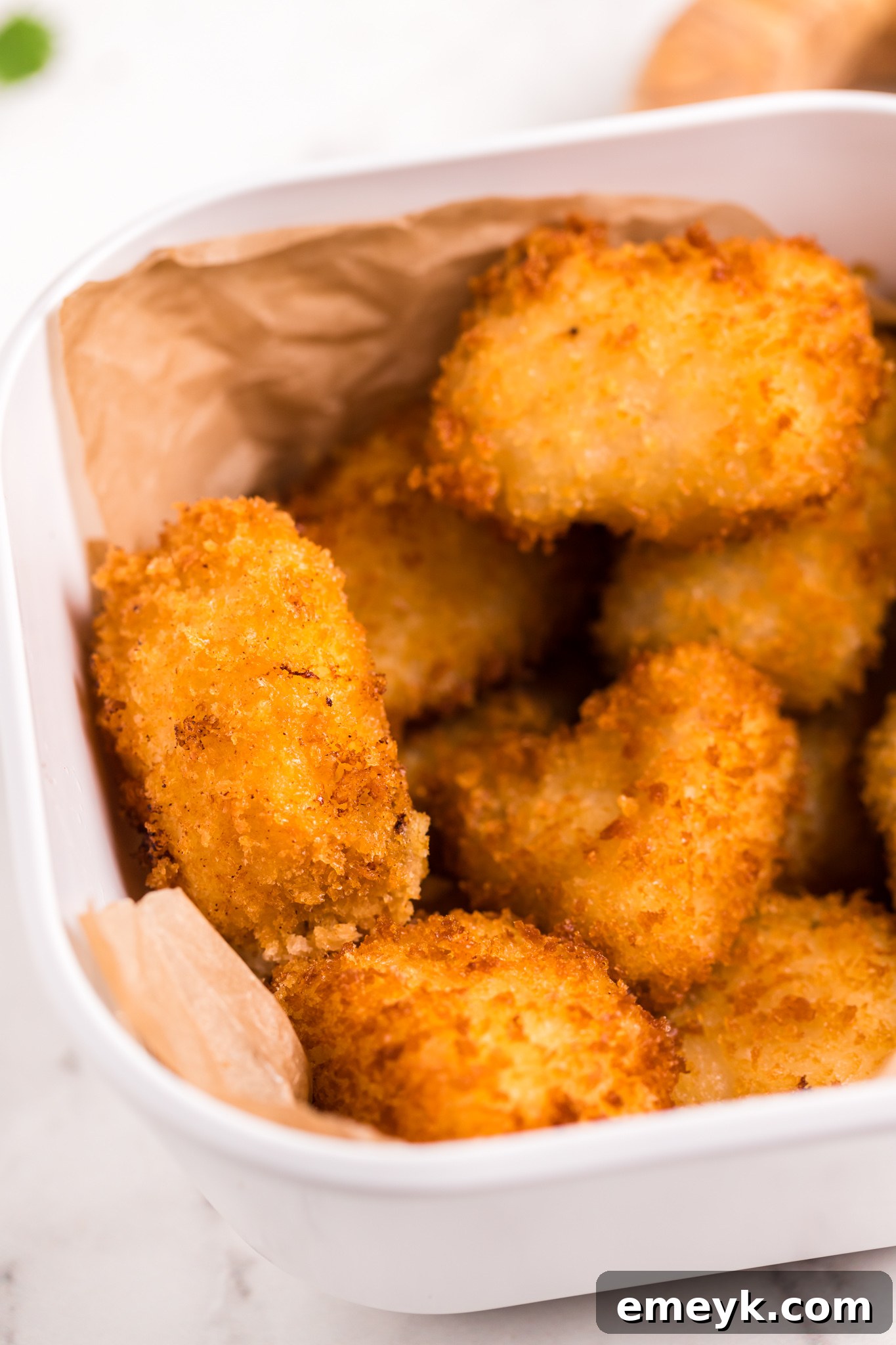 Crispy Air Fryer Tilapia 2 Air Fryer Tilapia in a basket, showcasing its golden, crispy crust.