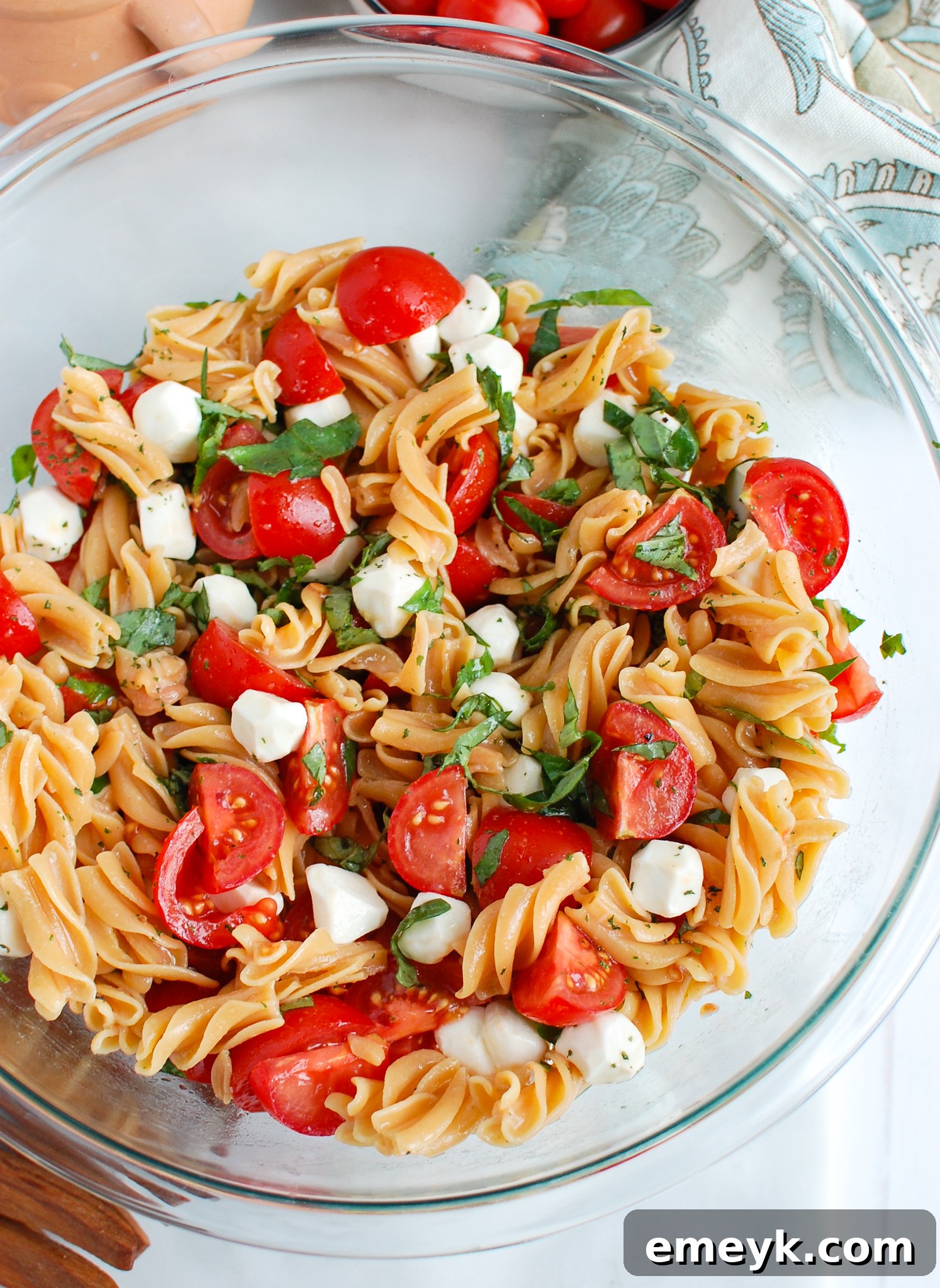 Caprese Pasta ready to serve in a clear glass bowl