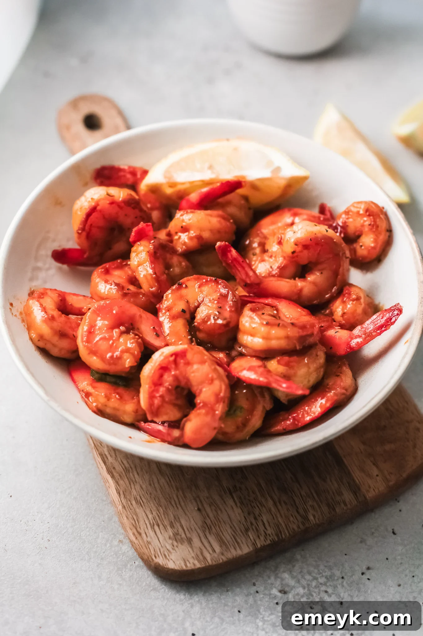 Easy Honey Cajun Shrimp served with a lemon wedge, ready to be enjoyed.