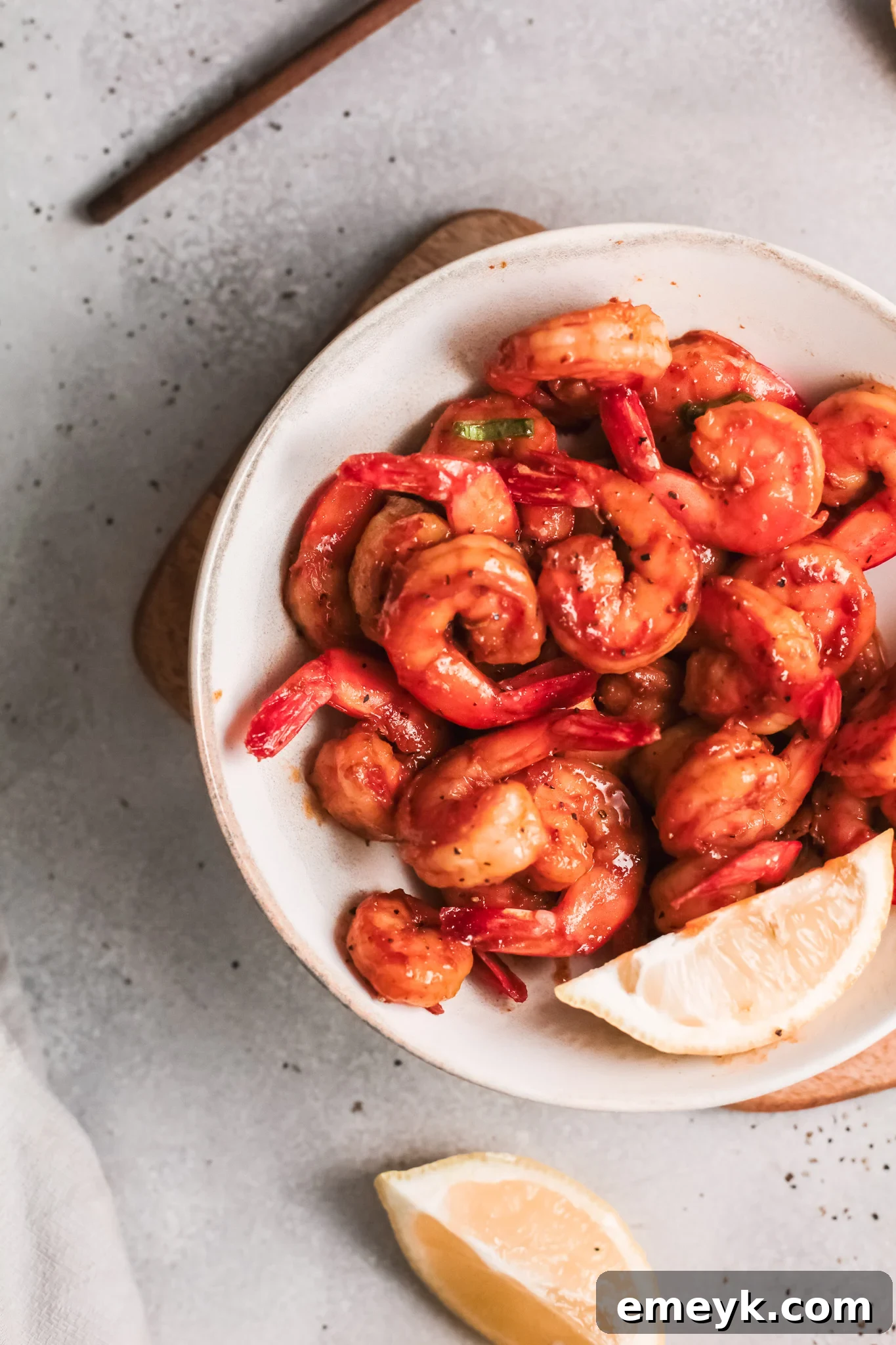 Easy Cajun Shrimp served in a bowl with a lemon slice garnish.