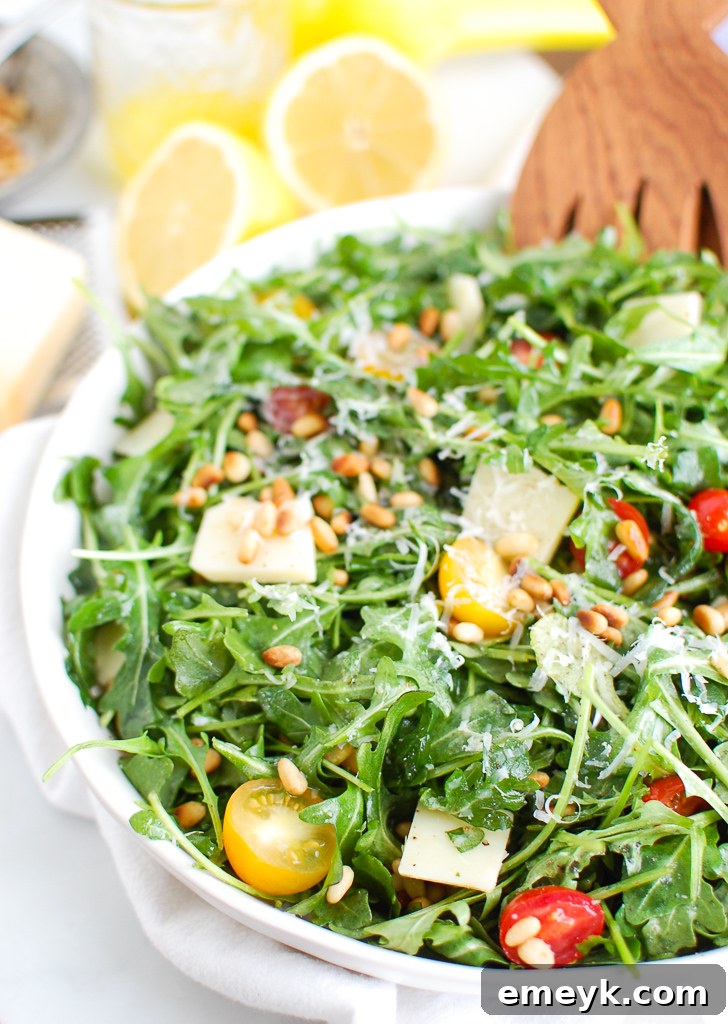 Quick and easy Lemon Arugula Salad with Pine Nuts, cherry tomatoes, and Parmesan.