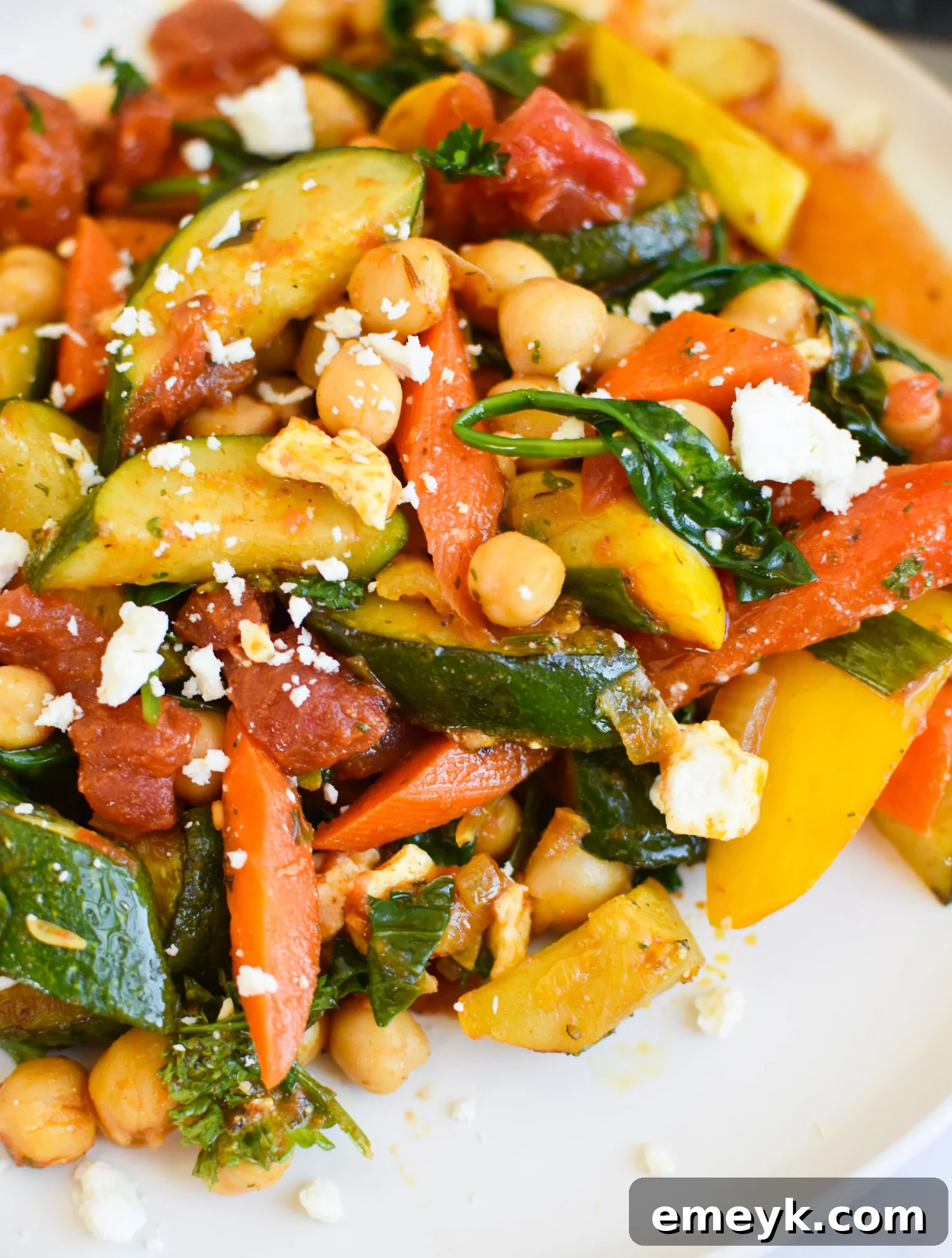 Vibrant Mediterranean Chickpea Skillet 2 Vibrant Mediterranean Chickpea Skillet garnished with feta cheese and fresh parsley, ready to be served.