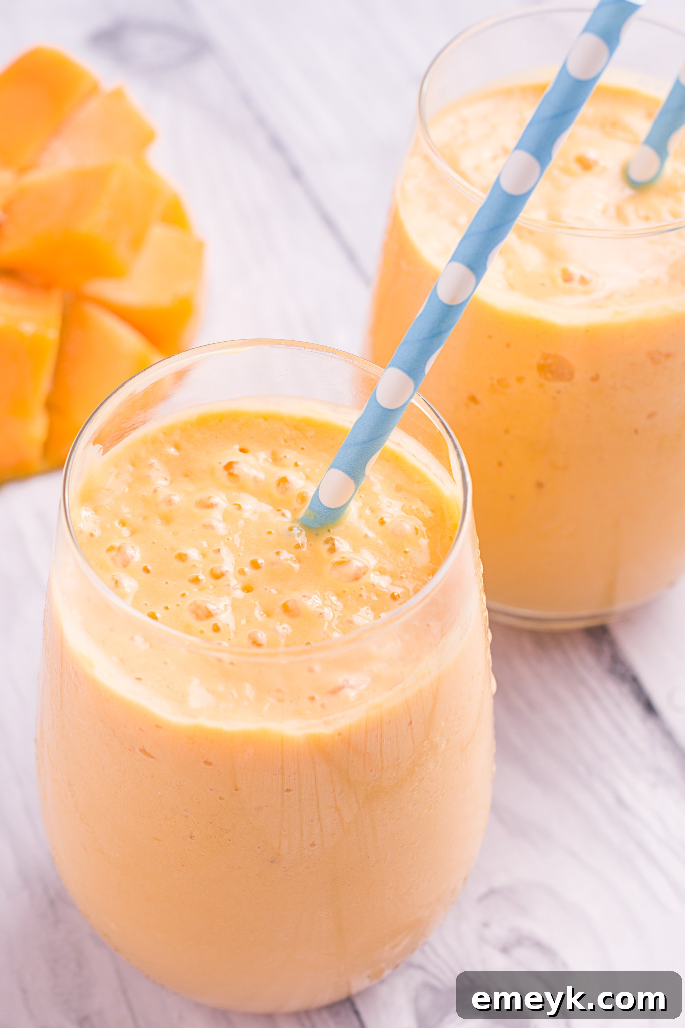 A tall glass of homemade Mango Lassi, perfectly blended and garnished, ready to be enjoyed.