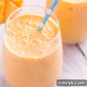 A vibrant and creamy Mango Lassi, ready to be served in a glass.