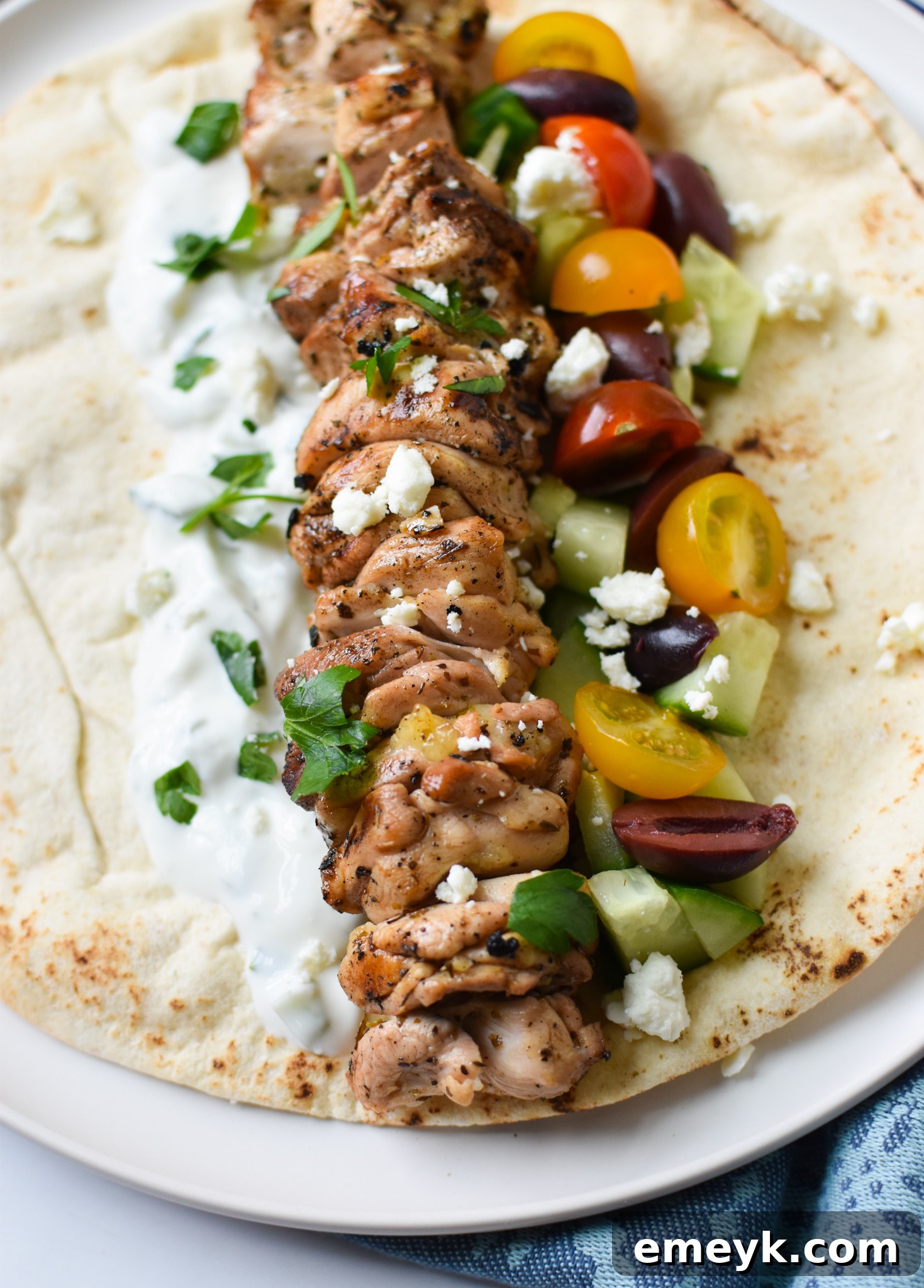 Flavorful Marinated Chicken Souvlaki 4 Chicken Souvlaki Recipe with tomatoes and feta cheese, served in a pita.