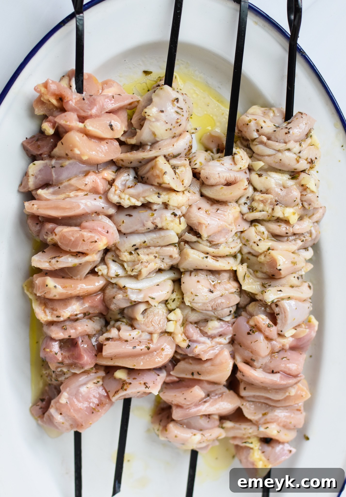 Flavorful Marinated Chicken Souvlaki 7 Chicken Souvlaki Recipe raw chicken cubes threaded onto skewers.
