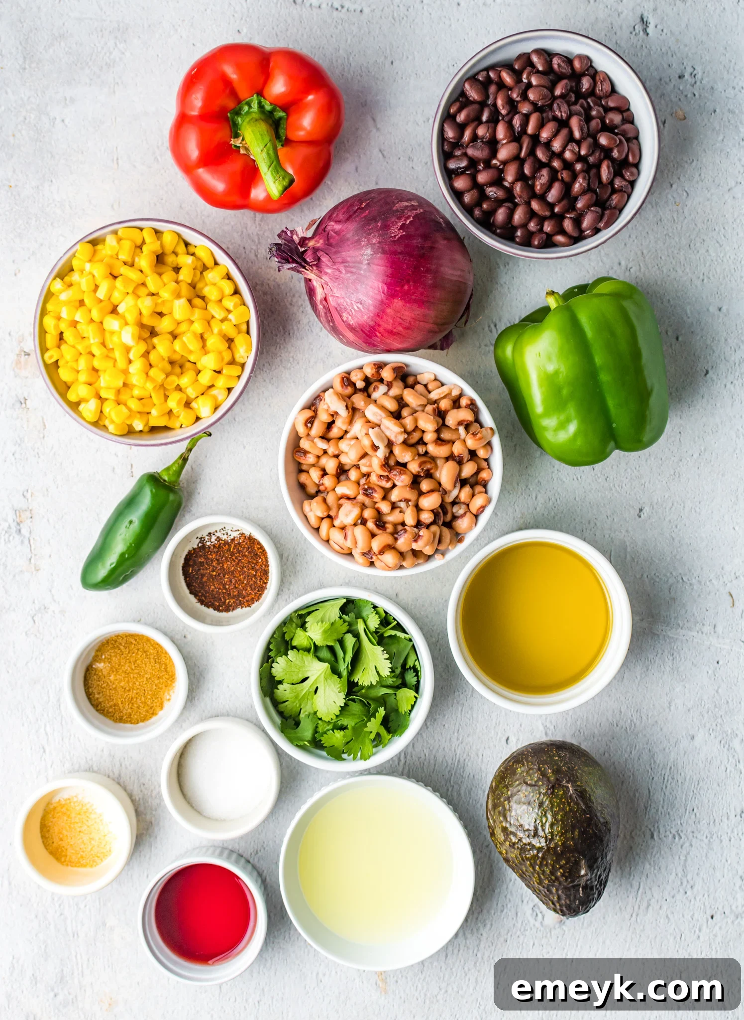 Zesty Cowboy Caviar Delight 3 All the fresh ingredients laid out for making Cowboy Caviar, including black eyed peas, corn, peppers, and cilantro.
