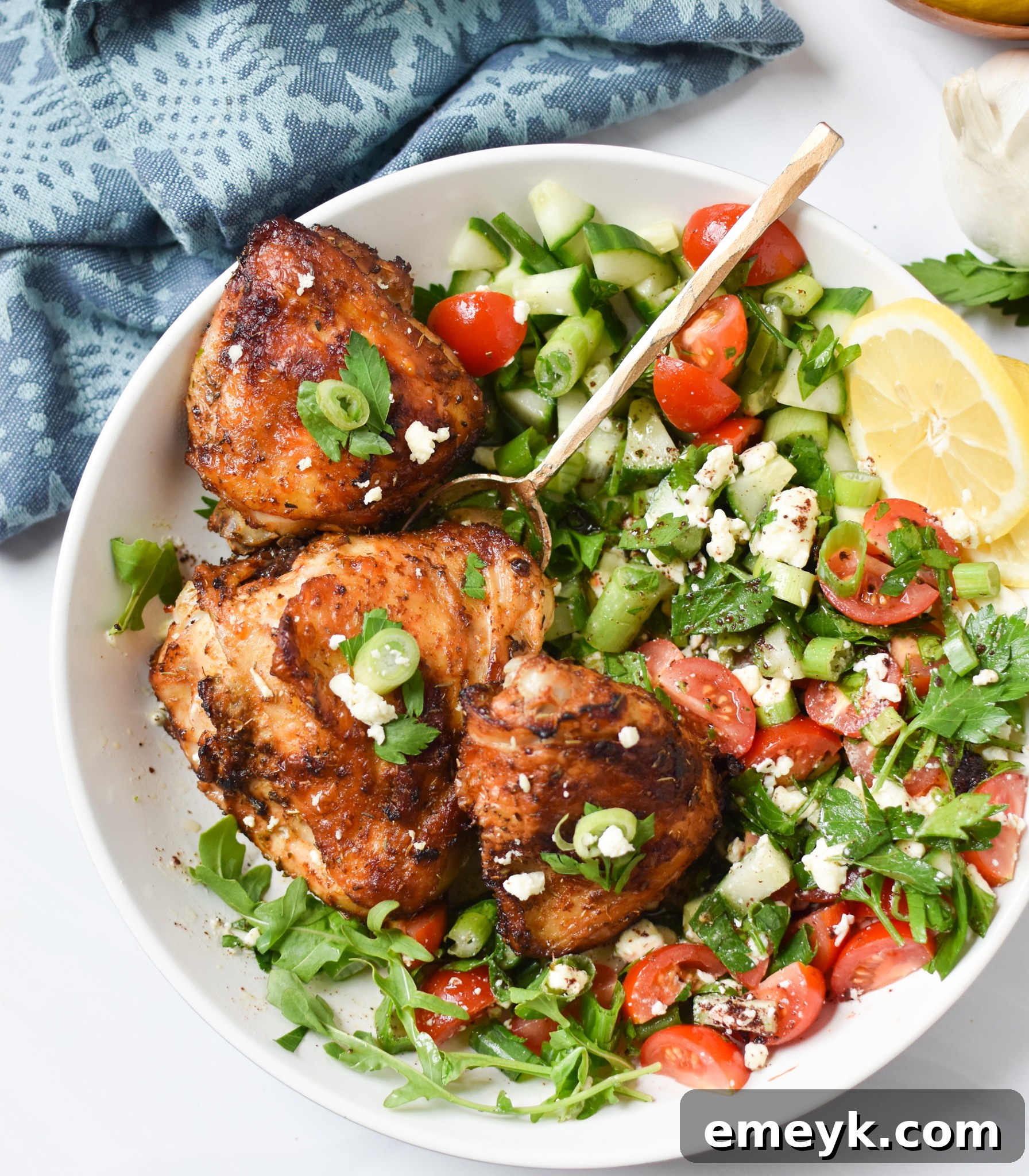 Marinated chicken thighs in a bowl, showing the vibrant seasoning.