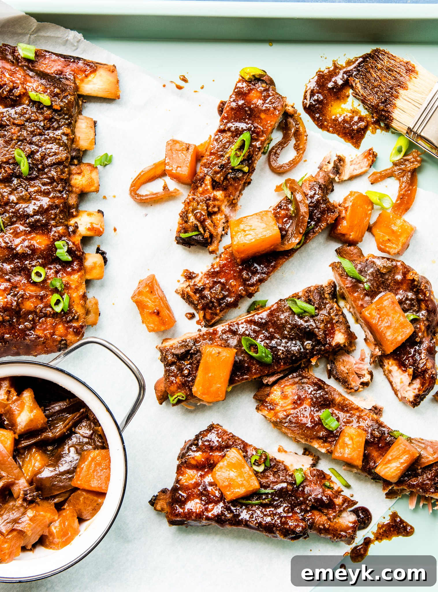 Slow Cooker Hawaiian Pork Ribs arranged on a baking sheet, ready for the slow cooker.