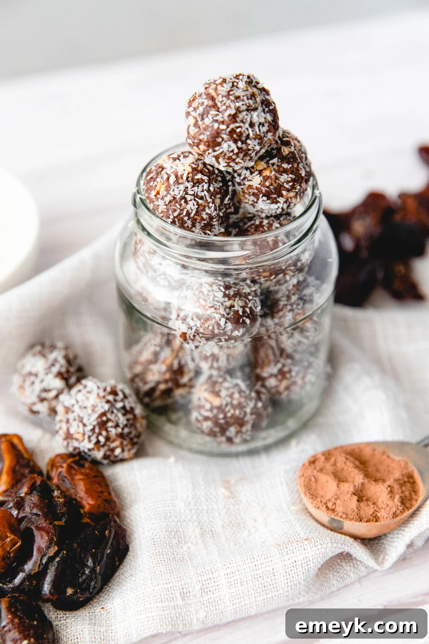 Easy Date Protein Balls in a glass jar, showcasing their appealing texture.