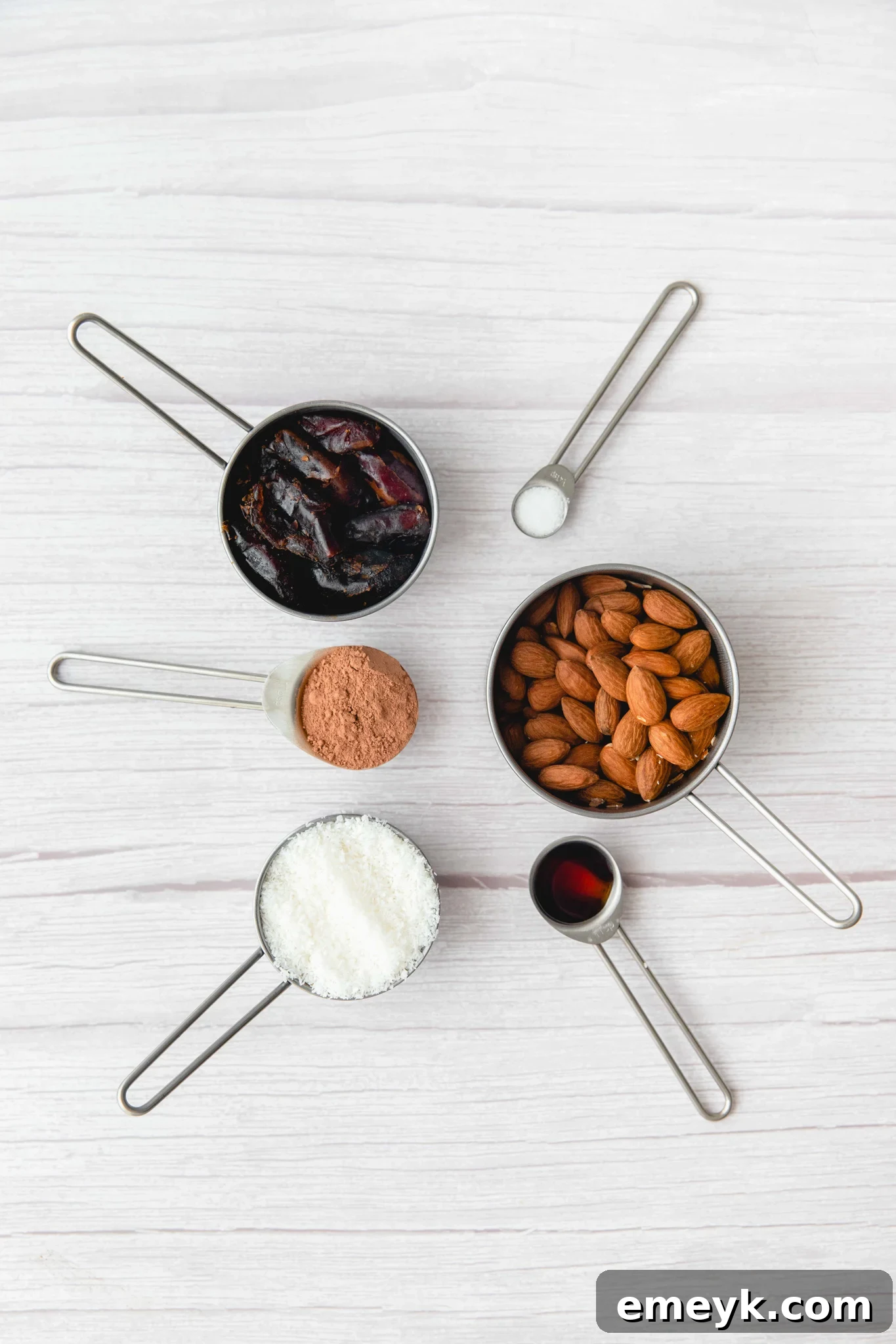 Collection of fresh ingredients for Easy Date Protein Balls, including Medjool dates, almonds, and desiccated coconut.