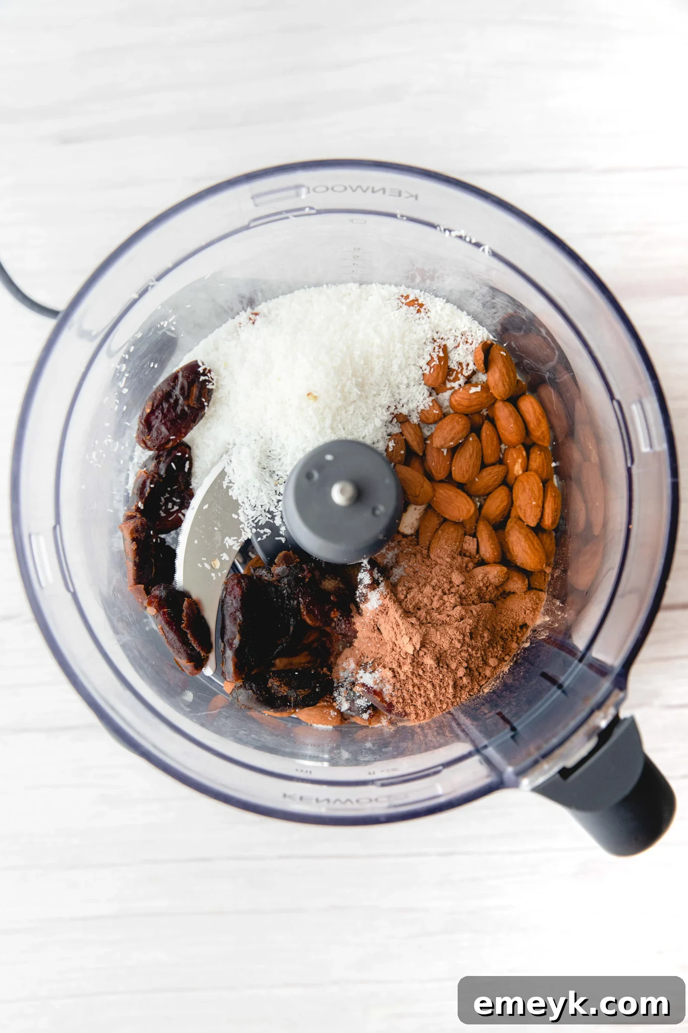 Ingredients for Easy Date Protein Balls being blended in a food processor.
