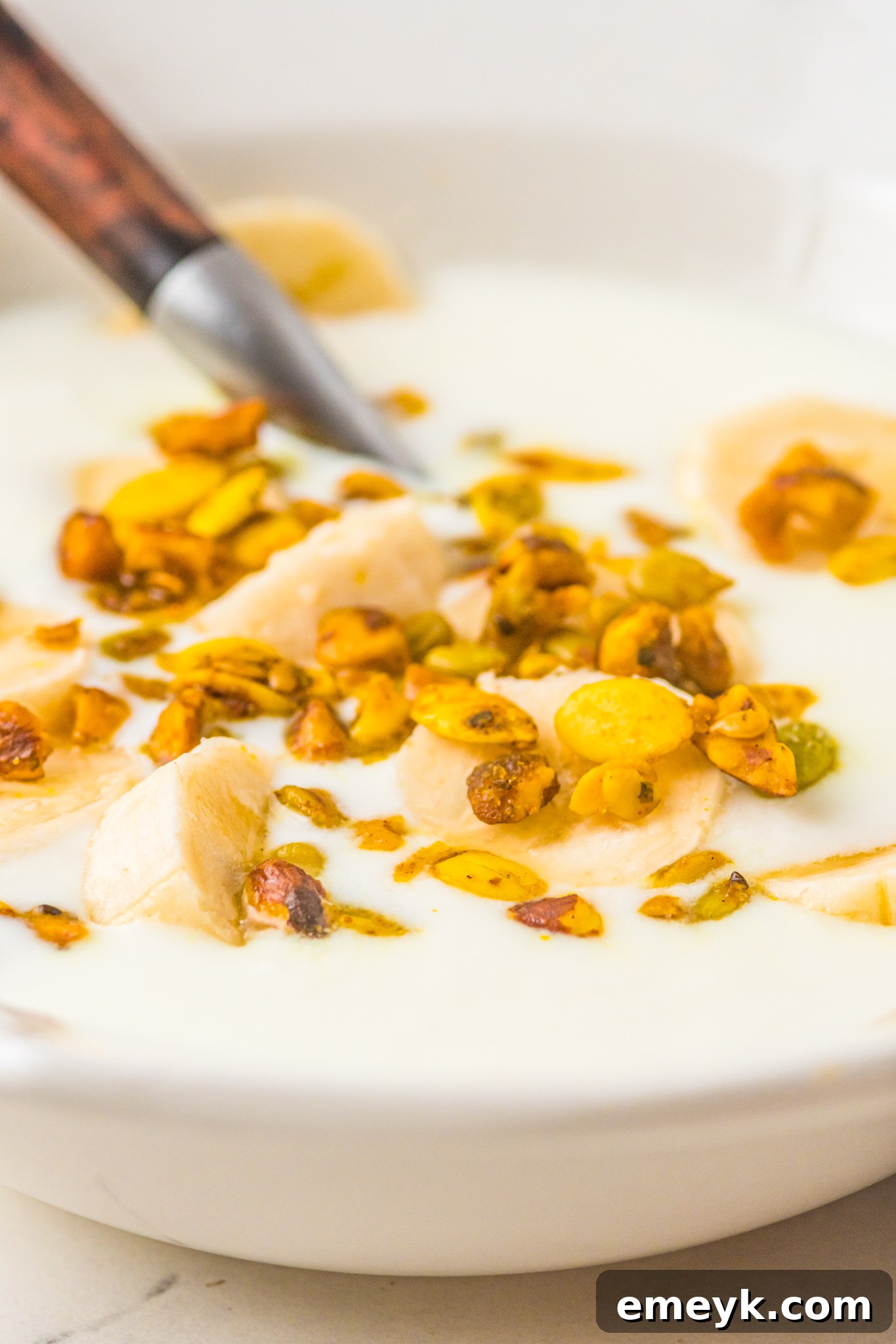 A bowl of Instant Pot Yogurt topped with granola, fresh berries, and a drizzle of honey, showcasing serving potential.