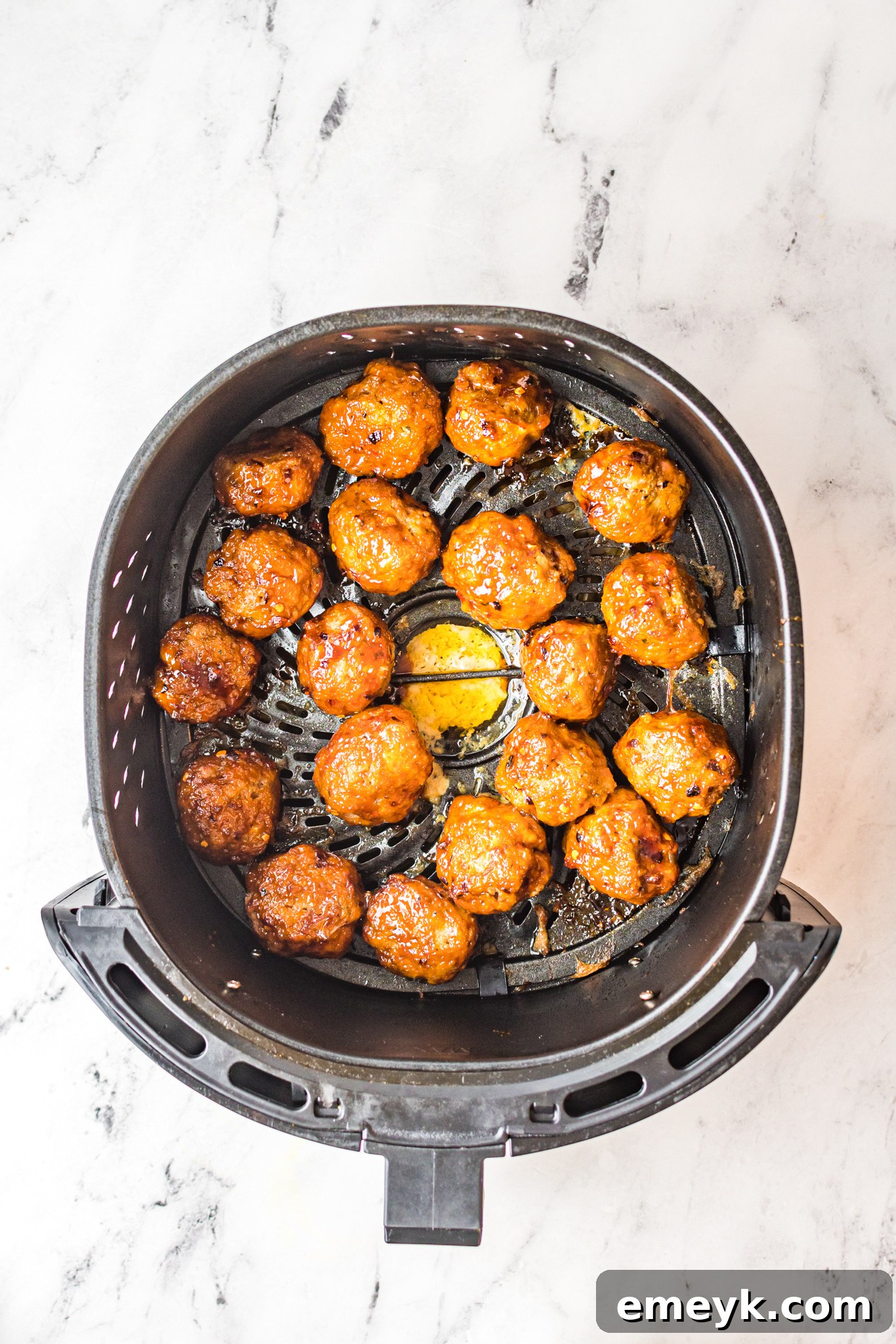 A fresh batch of Air Fryer Meatballs waiting in the air fryer basket.
