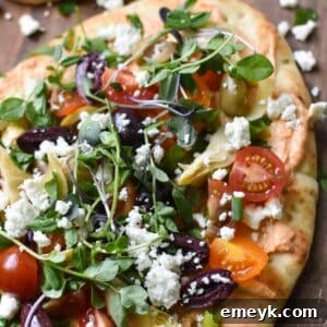 Mediterranean Naan Bread Pizza, close up of a slice.