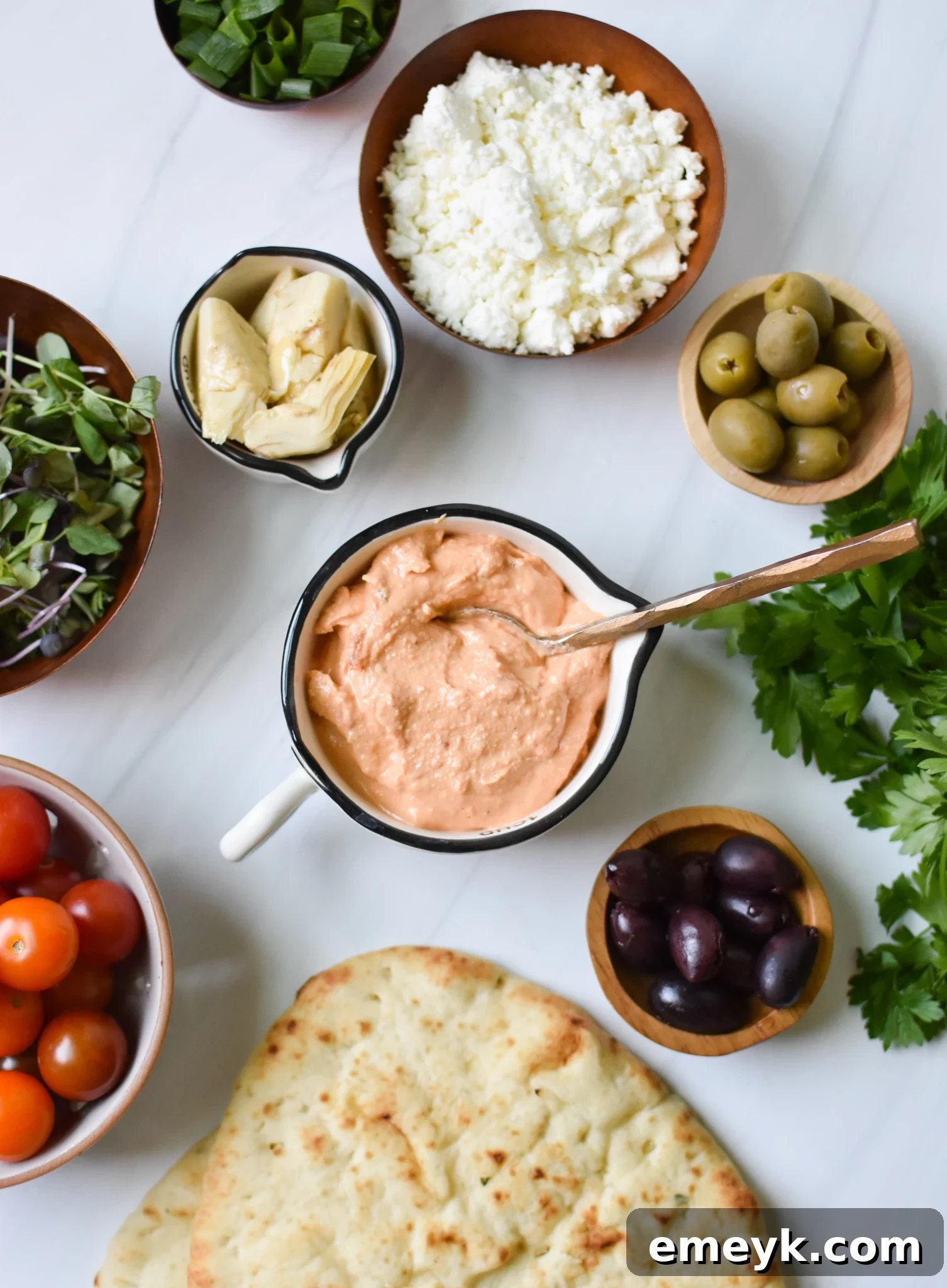 Mediterranean Naan Bread Pizza with all its fresh ingredients laid out before preparation.