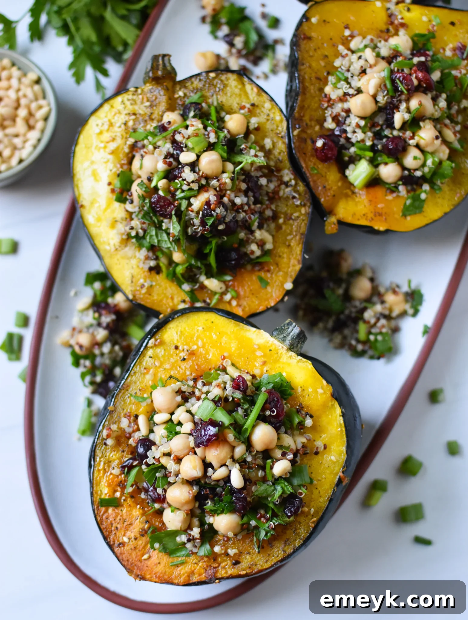 Mediterranean Stuffed Acorn Squash served on a white plate with a fork.