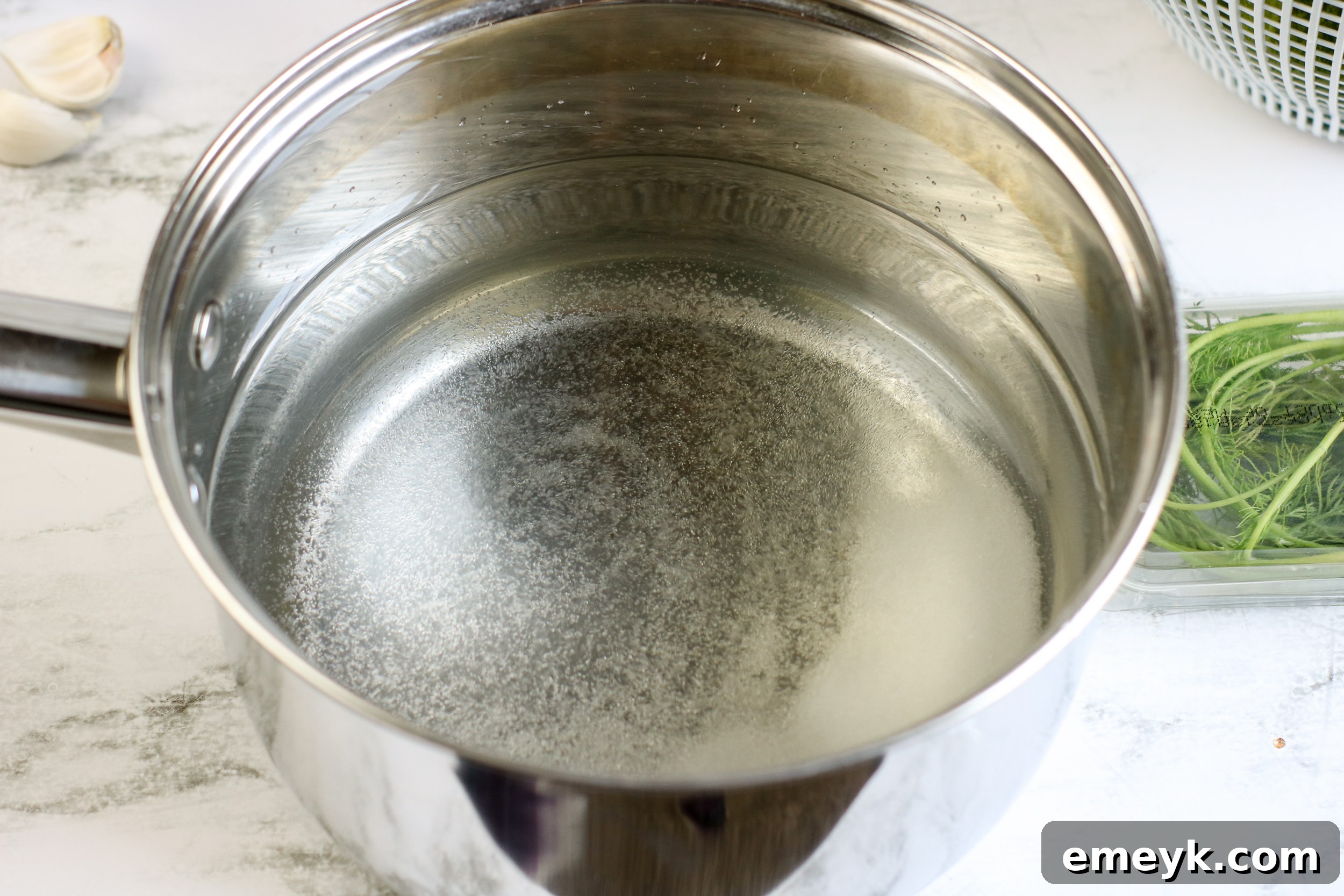 Brine mixture for Refrigerator Dill Pickles heating in a saucepan.