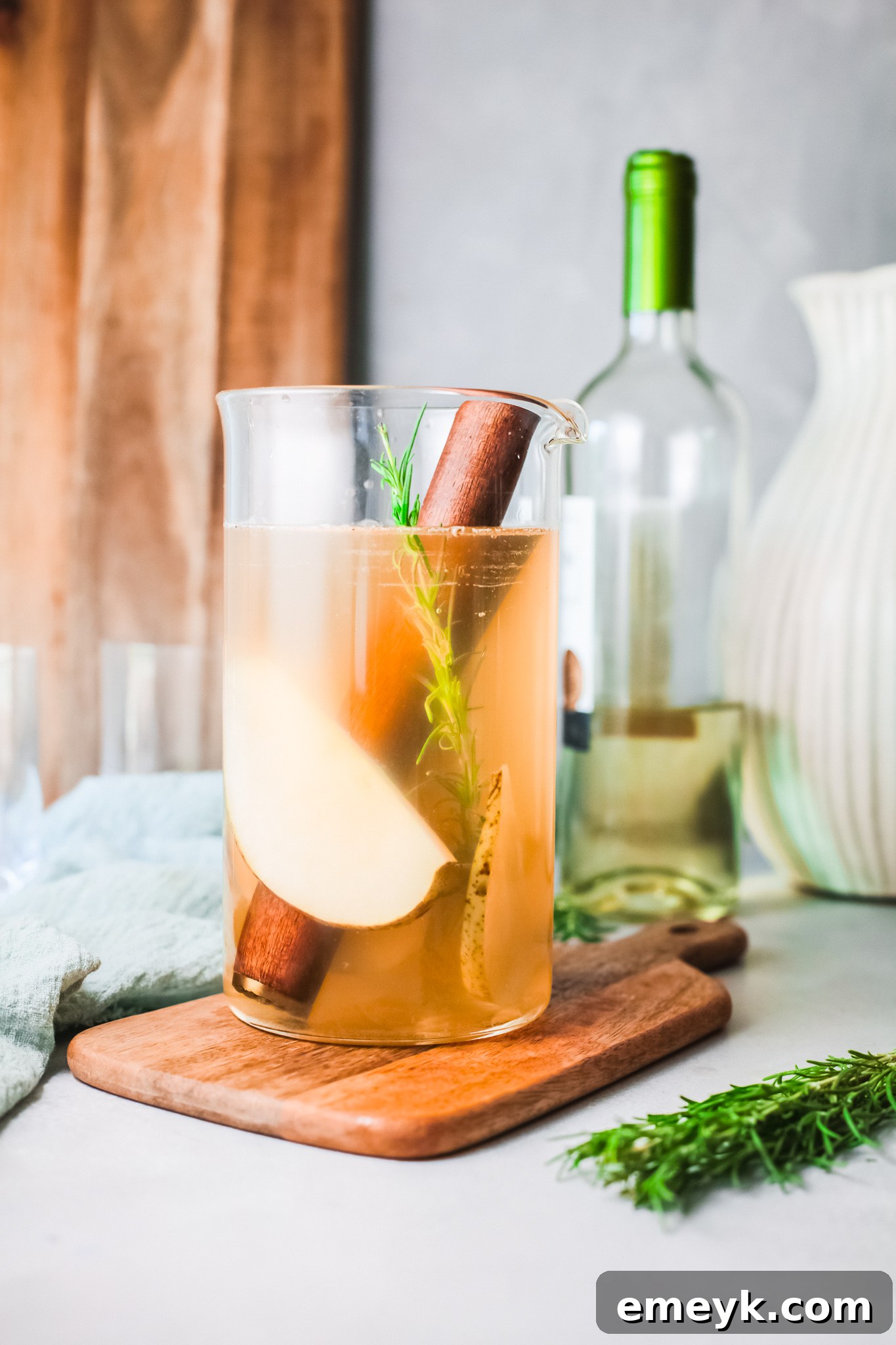 Pouring white wine into a pitcher for White Sangria.