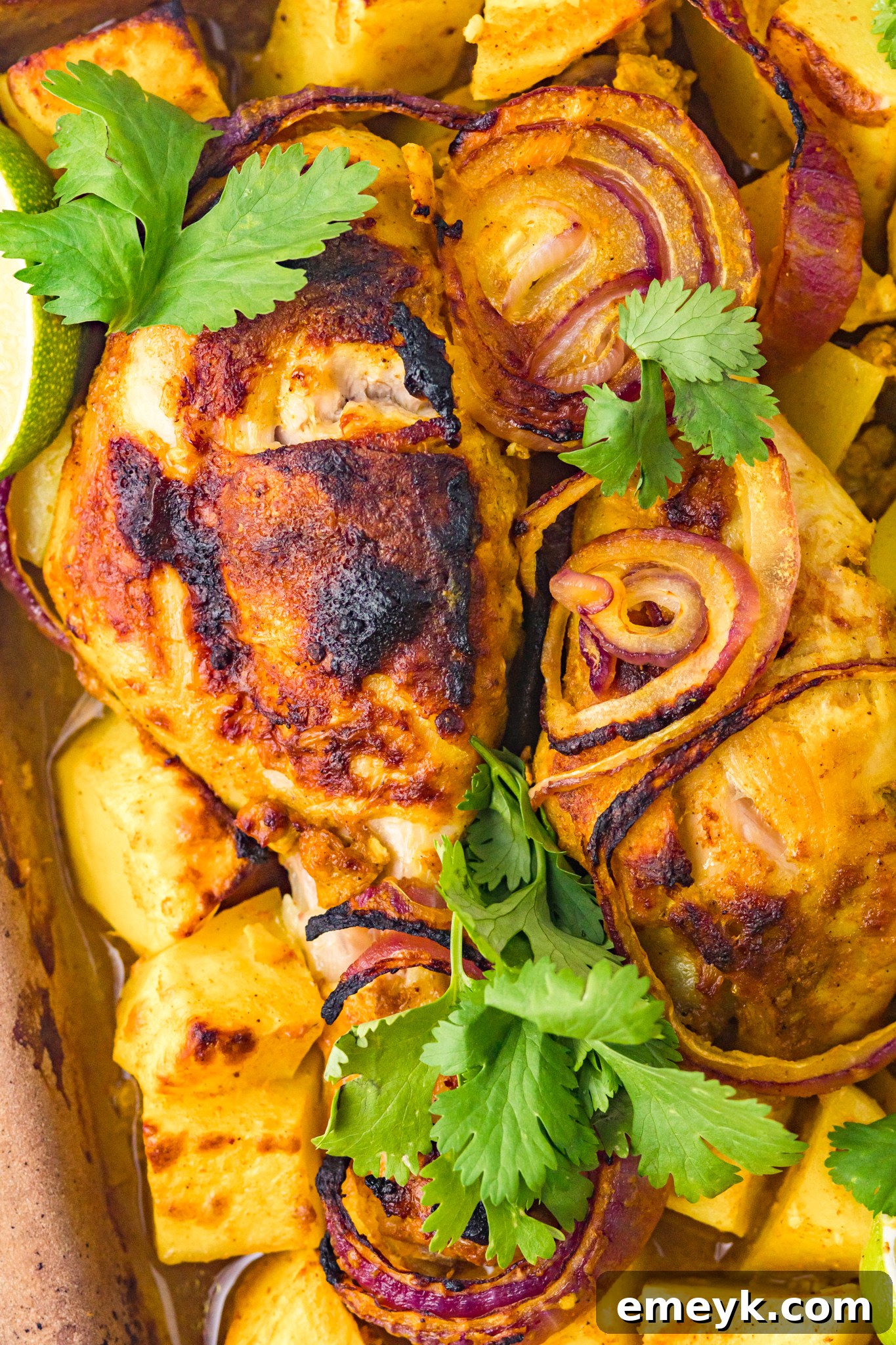Crispy Air Fryer Tandoori Chicken Legs 4 Cooked Air Fryer Tandoori Chicken Legs generously garnished with fresh cilantro, ready to be served.