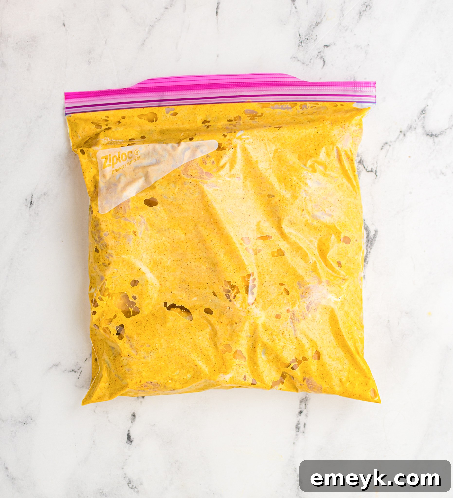Crispy Air Fryer Tandoori Chicken Legs 7 Chicken legs fully coated in Tandoori marinade inside a sealed ziplock bag.
