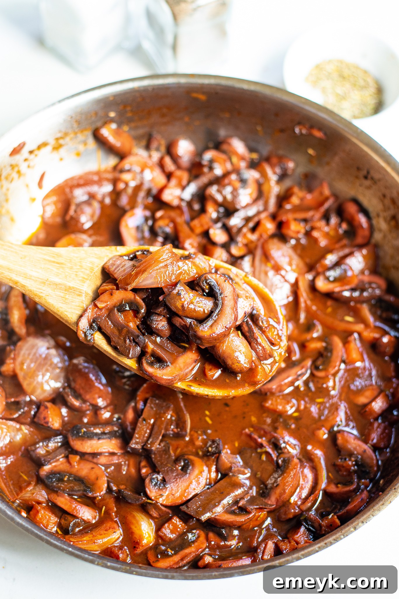 Mushroom Bourguignon simmering in a large pan.